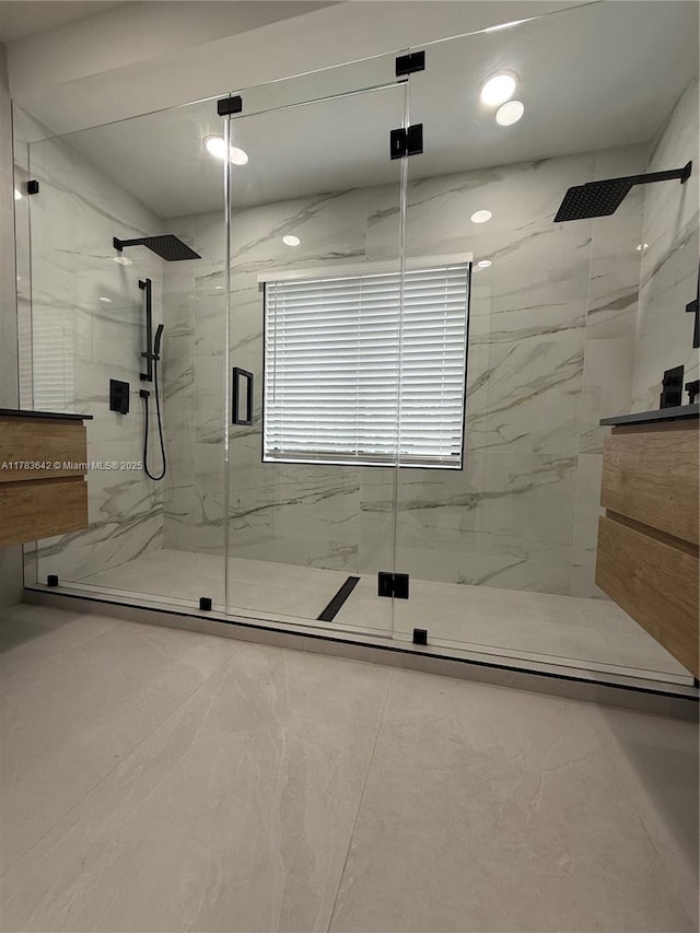 bathroom featuring marble finish floor, a marble finish shower, and recessed lighting