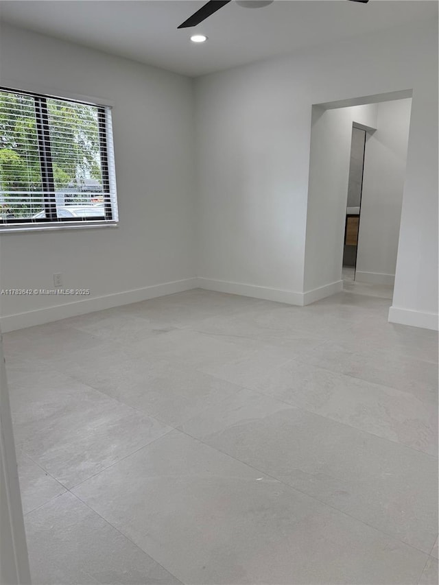 empty room featuring baseboards, a ceiling fan, and recessed lighting