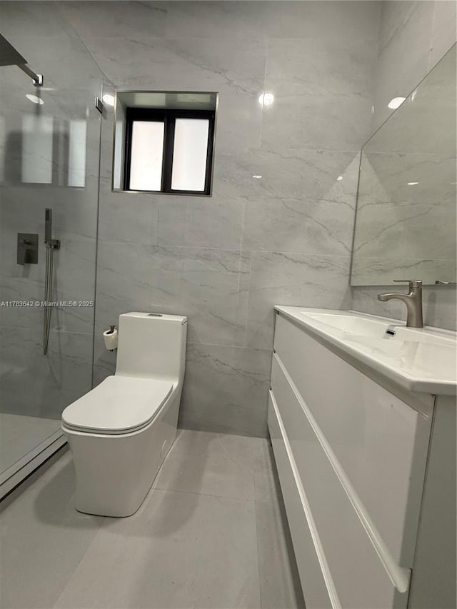bathroom featuring a walk in shower, vanity, and tile walls