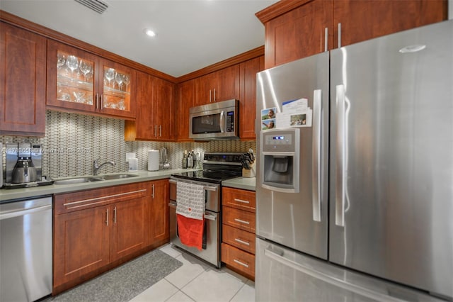 1950 S Ocean Dr Unit 17E, Hallandale Beach, FL 33009 - kitchen with light tile patterned floors, appliances with stainless steel finishes, light countertops, a sink, and decorative backsplash