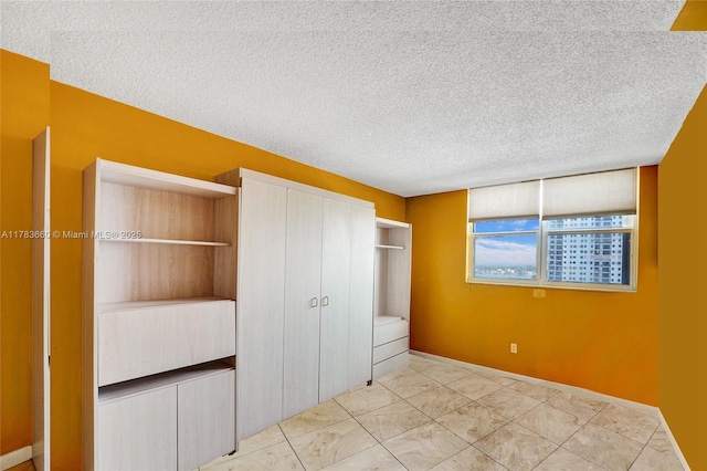 1401 S Ocean Dr Unit 902, Hollywood, FL 33019 - unfurnished bedroom with a textured ceiling, a closet, and baseboards