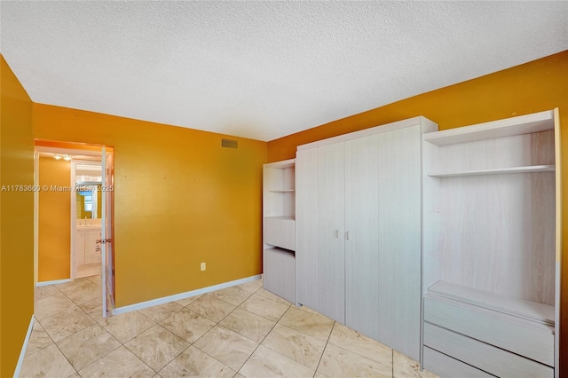 1401 S Ocean Dr Unit 902, Hollywood, FL 33019 - unfurnished bedroom featuring a closet, a textured ceiling, and baseboards