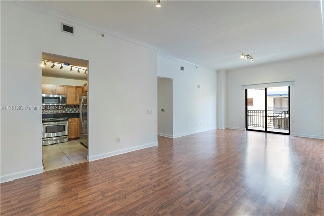 8390 SW 72nd Ave Unit 517, Miami, FL 33143 - spare room with rail lighting, crown molding, and light wood-type flooring
