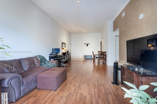 living area featuring crown molding and wood finished floors