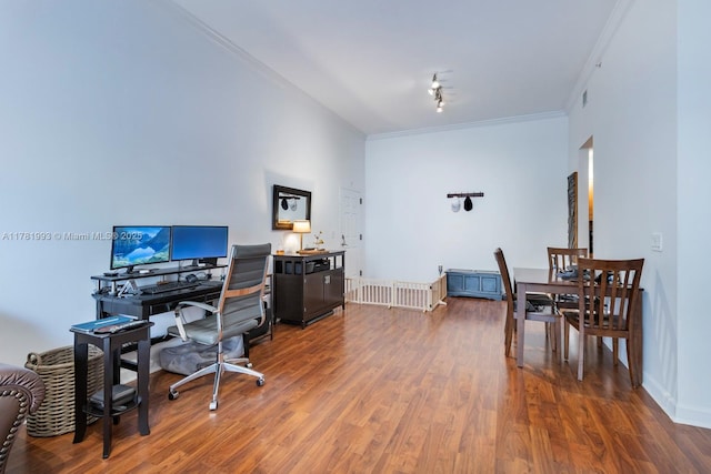 office area with rail lighting, ornamental molding, and wood finished floors