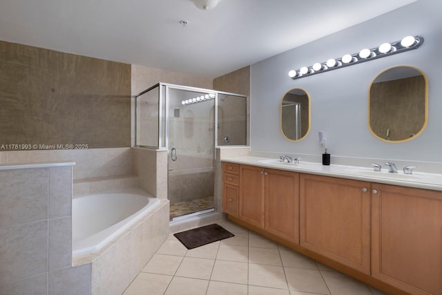 full bath with a shower stall, tile patterned floors, a garden tub, and a sink