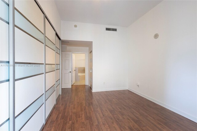 8390 SW 72nd Ave Unit 517, Miami, FL 33143 - unfurnished bedroom featuring dark wood-style flooring and baseboards