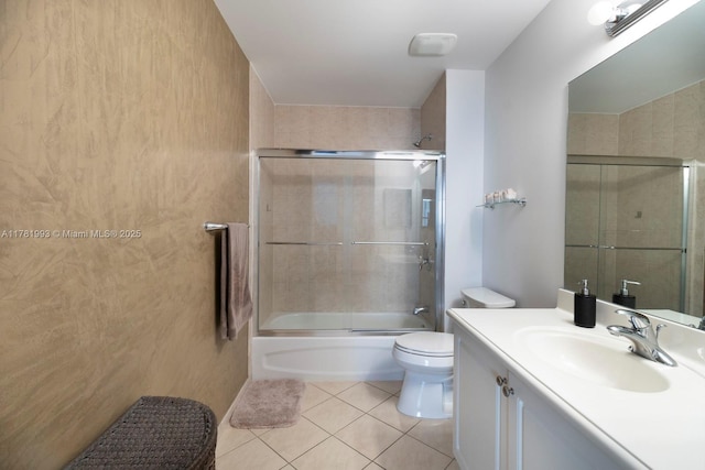 full bathroom featuring toilet, tile patterned floors, vanity, and enclosed tub / shower combo