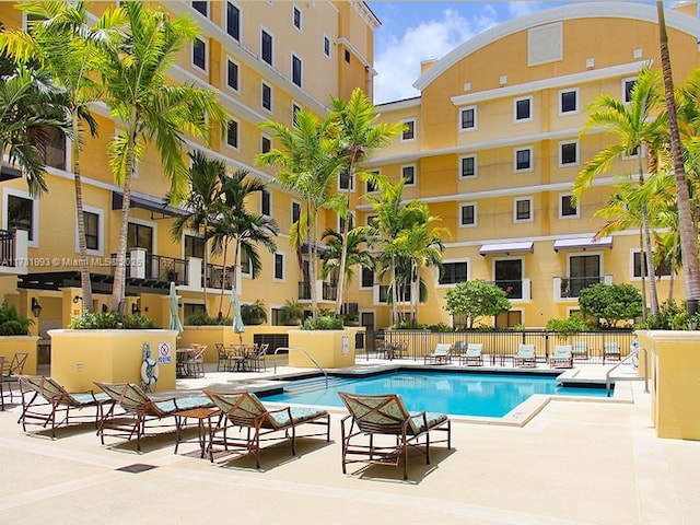 community pool featuring a patio and fence