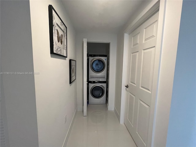 10950 NW 82nd St Unit 420, Doral, FL 33178 - hallway with light tile patterned floors, stacked washer and dryer, and baseboards