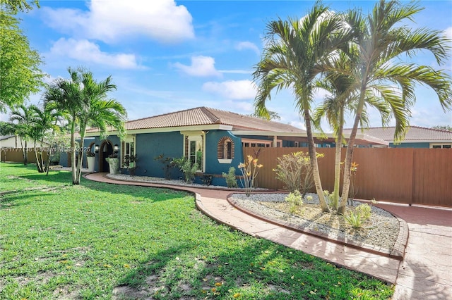 single story home with stucco siding, fence, a front lawn, and a tile roof