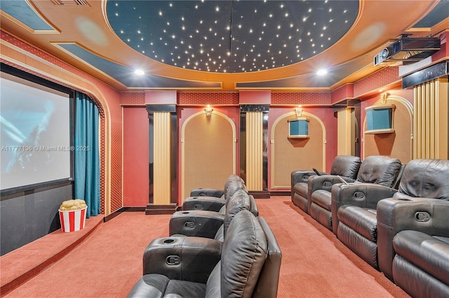 carpeted home theater room featuring baseboards, ornamental molding, and decorative columns