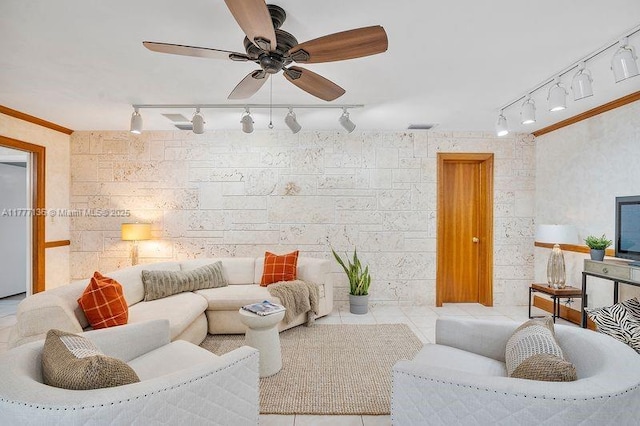 living area with tile patterned flooring, rail lighting, visible vents, a ceiling fan, and crown molding
