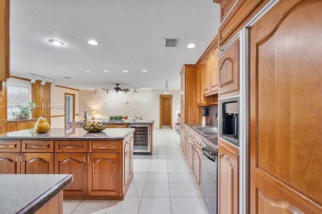 kitchen with recessed lighting, black dishwasher, light tile patterned flooring, visible vents, and beverage cooler