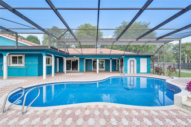 outdoor pool featuring a lanai and a patio area