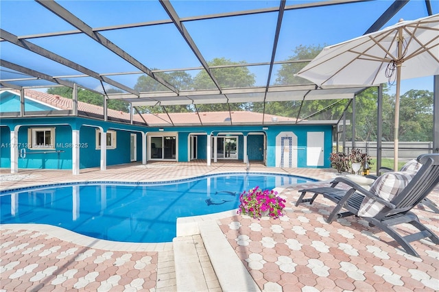 outdoor pool with a patio and a lanai
