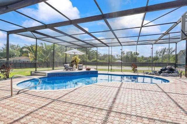 outdoor pool with fence, a patio area, and glass enclosure