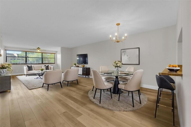 10400 NW 30th Ct Unit 203, Sunrise, FL 33322 - dining room with baseboards, ceiling fan with notable chandelier, and wood finished floors