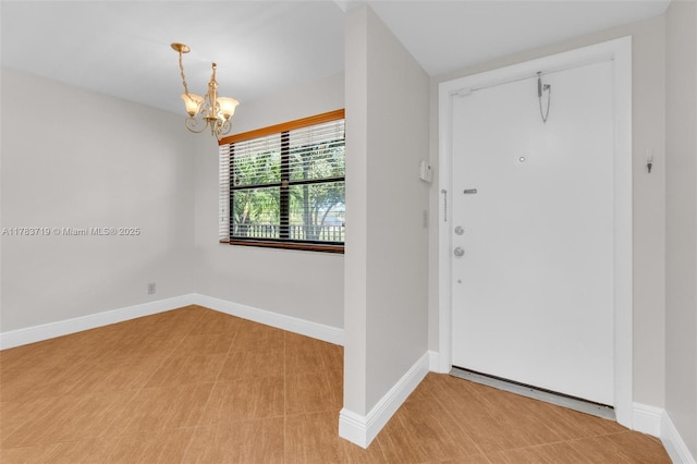 10400 NW 30th Ct Unit 203, Sunrise, FL 33322 - foyer entrance featuring baseboards and a chandelier