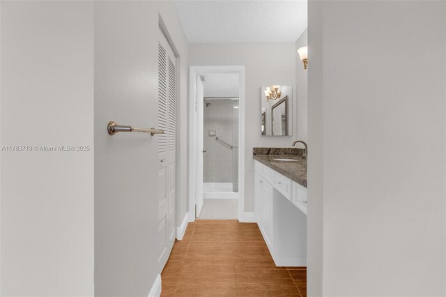 10400 NW 30th Ct Unit 203, Sunrise, FL 33322 - bathroom with vanity, baseboards, and a stall shower