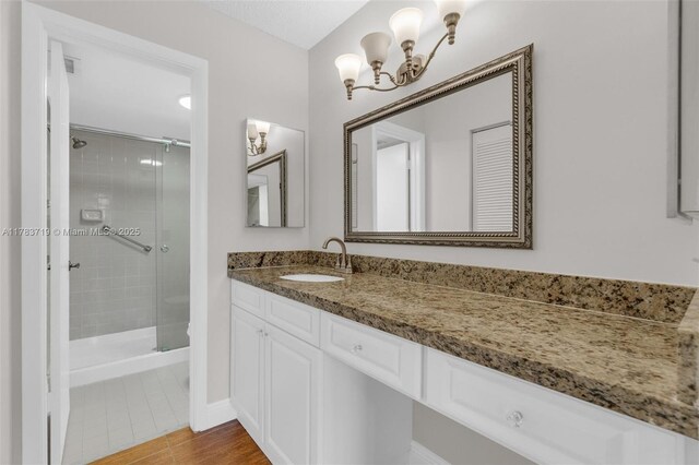 10400 NW 30th Ct Unit 203, Sunrise, FL 33322 - bathroom with a notable chandelier, a shower stall, and vanity