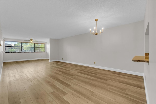 10400 NW 30th Ct Unit 203, Sunrise, FL 33322 - unfurnished room featuring baseboards, light wood-style flooring, and ceiling fan with notable chandelier