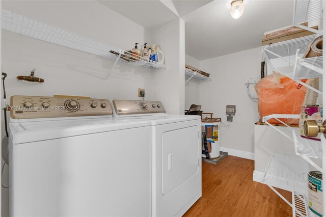 10400 NW 30th Ct Unit 203, Sunrise, FL 33322 - laundry room featuring laundry area, baseboards, light wood-style flooring, and washing machine and dryer
