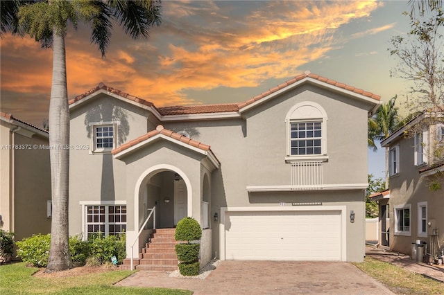 922 NW 127th Ave, Coral Springs, FL 33071 - mediterranean / spanish-style house with stucco siding, a tiled roof, an attached garage, and decorative driveway