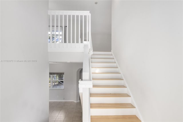 922 NW 127th Ave, Coral Springs, FL 33071 - stairway featuring a high ceiling, arched walkways, and tile patterned floors