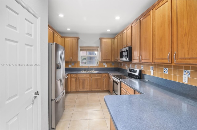 922 NW 127th Ave, Coral Springs, FL 33071 - kitchen with appliances with stainless steel finishes, brown cabinetry, tasteful backsplash, dark countertops, and recessed lighting