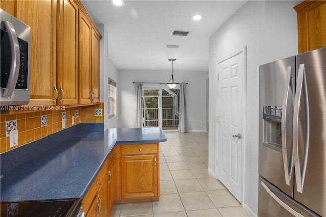 922 NW 127th Ave, Coral Springs, FL 33071 - kitchen featuring appliances with stainless steel finishes, brown cabinetry, decorative backsplash, a peninsula, and recessed lighting