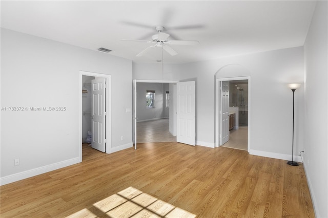 922 NW 127th Ave, Coral Springs, FL 33071 - unfurnished bedroom with light wood-style floors, a walk in closet, connected bathroom, and ceiling fan