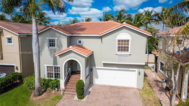 922 NW 127th Ave, Coral Springs, FL 33071 - mediterranean / spanish-style house featuring a tile roof, stucco siding, a garage, and decorative driveway