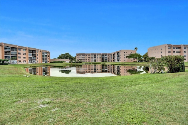 10451 Sunrise Lakes Blvd Unit 401, Sunrise, FL 33322 - view of property's community with a water view and a lawn