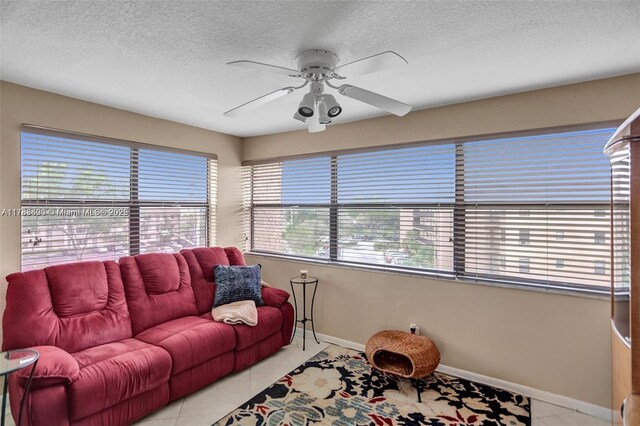 10451 Sunrise Lakes Blvd Unit 401, Sunrise, FL 33322 - tiled living room with baseboards, ceiling fan, and a textured ceiling