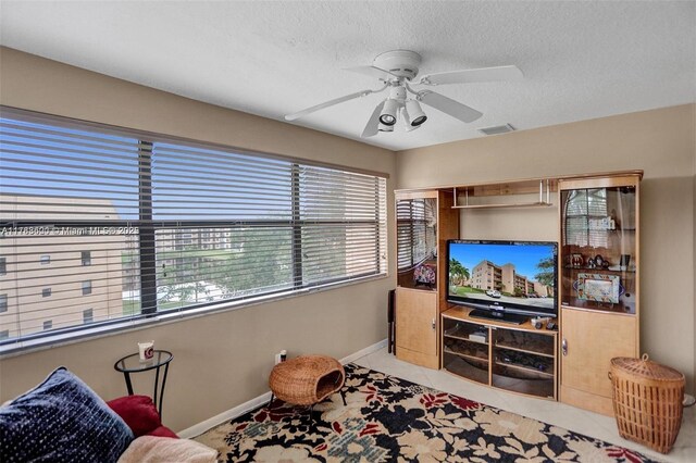 10451 Sunrise Lakes Blvd Unit 401, Sunrise, FL 33322 - tiled living room with a textured ceiling, baseboards, a ceiling fan, and visible vents