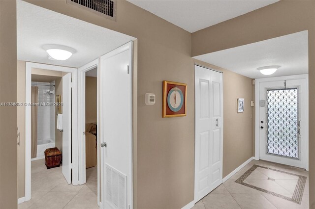 10451 Sunrise Lakes Blvd Unit 401, Sunrise, FL 33322 - foyer entrance with visible vents, baseboards, and light tile patterned flooring