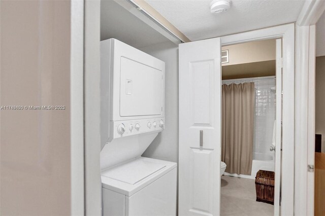 10451 Sunrise Lakes Blvd Unit 401, Sunrise, FL 33322 - clothes washing area with laundry area and stacked washer / drying machine