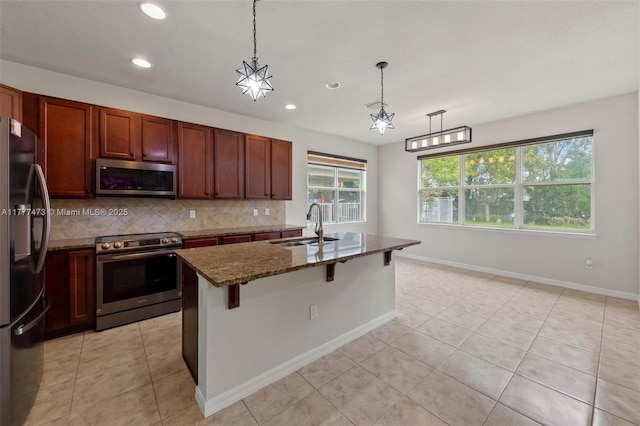 4233 Large Leaf Ln, Hollywood, FL 33021 - kitchen with dark stone counters, recessed lighting, a sink, stainless steel appliances, and backsplash
