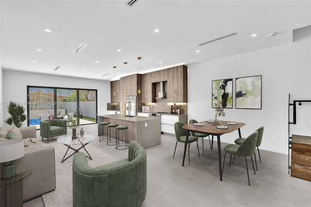 living room with concrete floors, visible vents, and recessed lighting