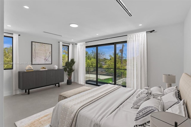 carpeted bedroom with recessed lighting, visible vents, and access to exterior