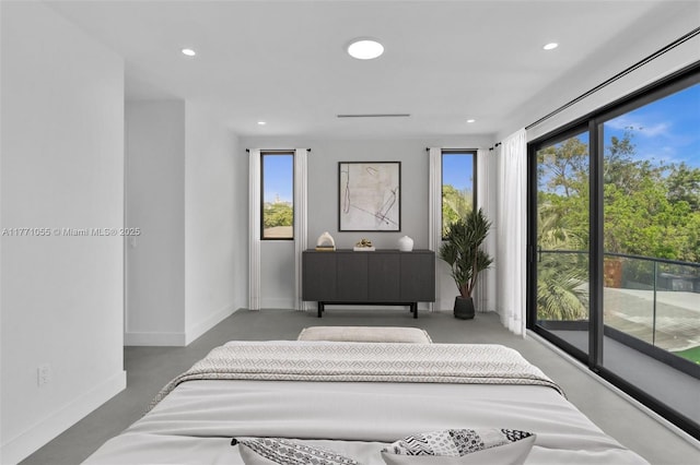 bedroom featuring concrete floors, baseboards, and recessed lighting