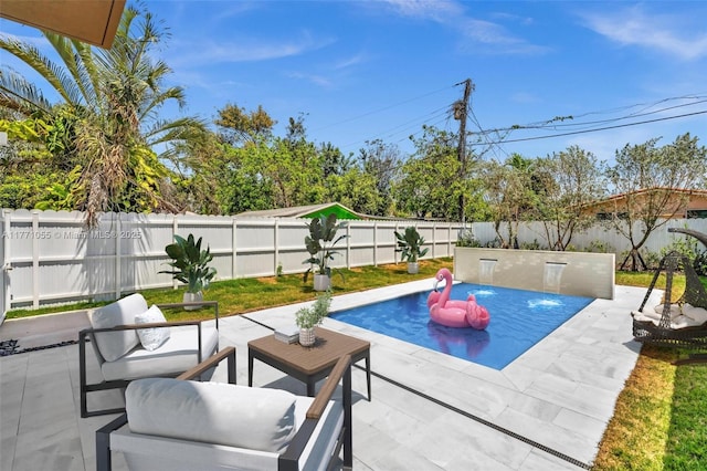 view of pool with a fenced backyard and a patio
