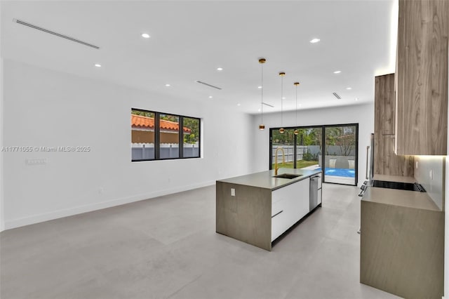 kitchen featuring a center island with sink, modern cabinets, stainless steel dishwasher, a sink, and stovetop