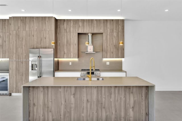 kitchen featuring high quality fridge, light countertops, modern cabinets, and concrete floors