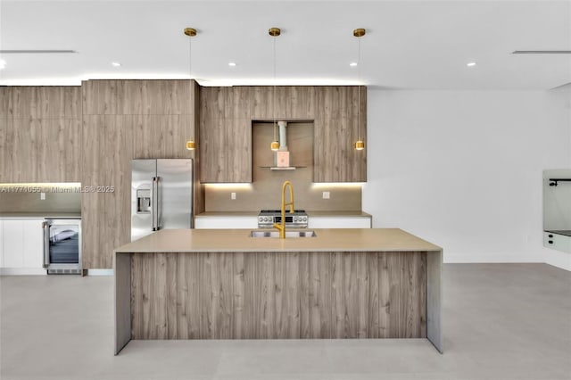 kitchen featuring modern cabinets, a sink, light countertops, finished concrete flooring, and high end refrigerator