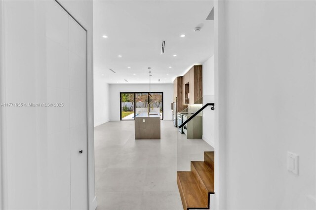 hall featuring visible vents and recessed lighting