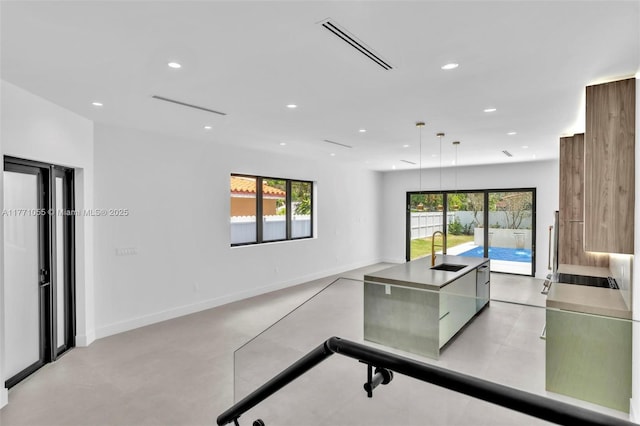 interior space with recessed lighting, visible vents, baseboards, and a sink