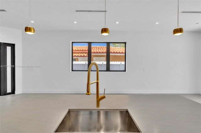 kitchen featuring a sink, recessed lighting, and decorative light fixtures