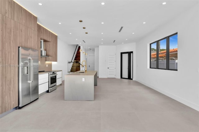 kitchen featuring stainless steel appliances, recessed lighting, modern cabinets, and a sink